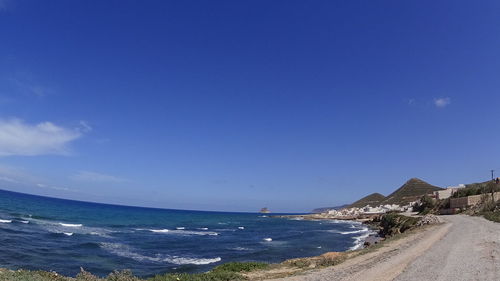 View of beach against blue sky