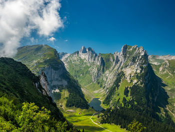 Panoramic view of landscape and mountains against blue sky