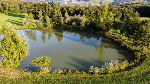 Aerial view from the drone of a little lake in italian hills 