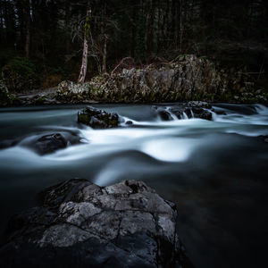 River flowing through rocks in forest