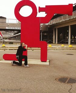 Full length of man with text on road