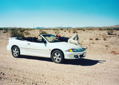 Vintage car on road against clear sky