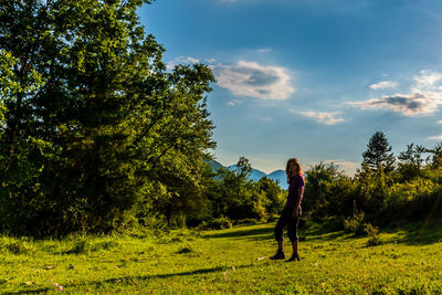Man standing on field against sky