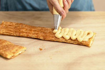 Midsection of man preparing food on cutting board