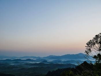 Scenic view of silhouette mountains against clear sky at sunset