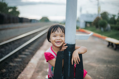Portrait of smiling girl standing on road