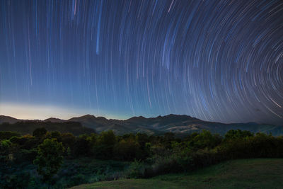 Scenic view of landscape against sky at night