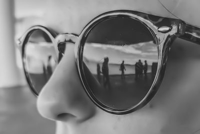 Reflection of woman photographing on mirror