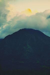 Low angle view of silhouette mountains against sky