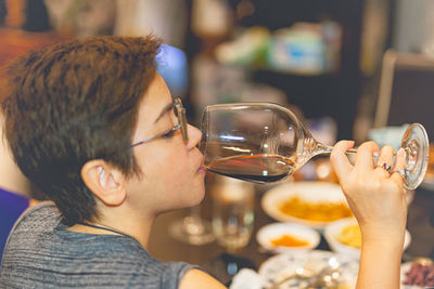 Portrait of woman short hair drinking red wine