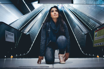 Full length of young woman looking up