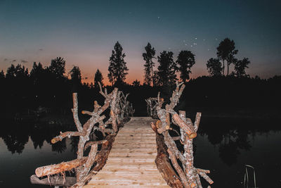 Scenic view of lake against sky at night