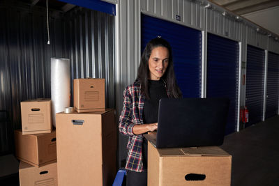 Portrait of smiling young woman standing in box