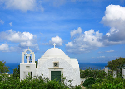 Church by building against sky