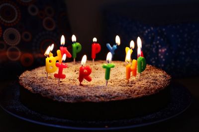 Close up of multi colored candles on birthday cake