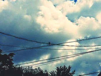 Low angle view of electricity pylon against sky