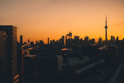 Skyline of toronto casting dark shadows at sunrise