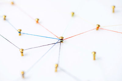 Low angle view of power lines over white background