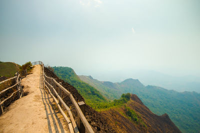 Panoramic view of road leading towards mountains against sky