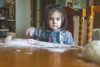 Cute girl making cookie at home