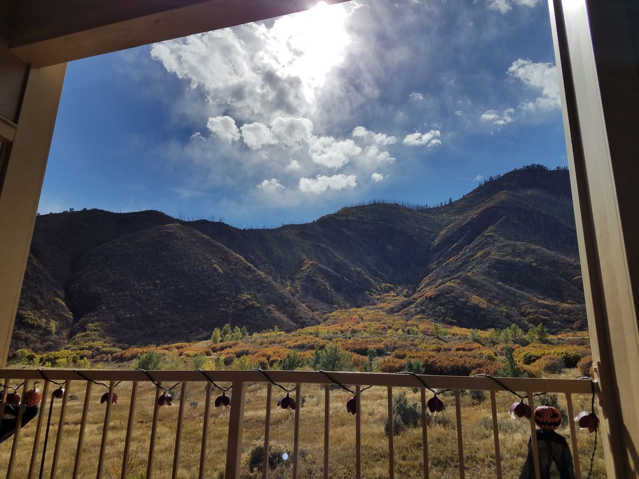 sky, mountain, railing, cloud - sky, tree, outdoors, nature, built structure, day, beauty in nature, architecture, large group of people, people