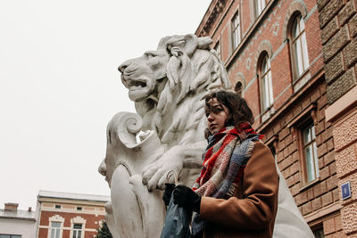 Low angle view of statue against building in city