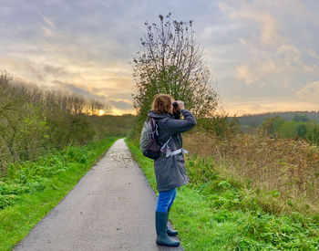 Side view of woman walking on road