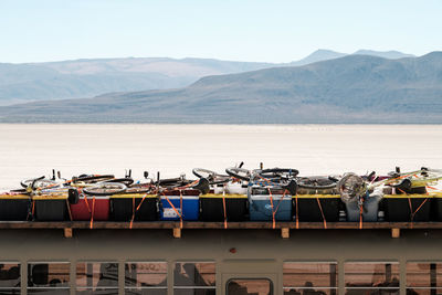 Boats moored on shore against sky