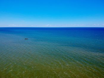 Scenic view of sea against blue sky