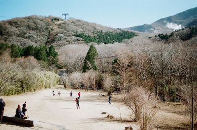 Panoramic view of people on landscape against sky