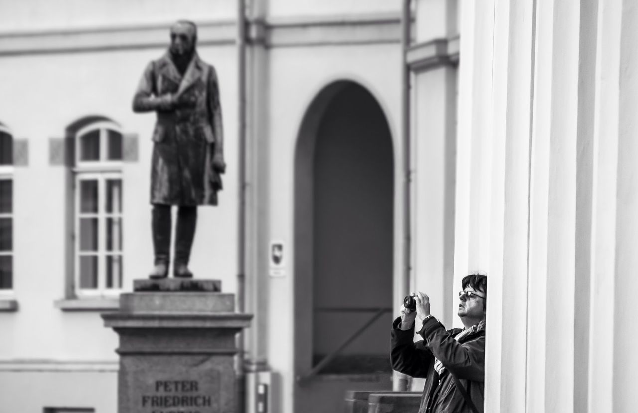 indoors, men, architecture, built structure, religion, lifestyles, rear view, person, human representation, standing, spirituality, statue, place of worship, leisure activity, day, arch, famous place