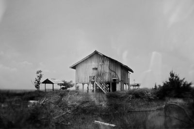 Abandoned house on field against sky