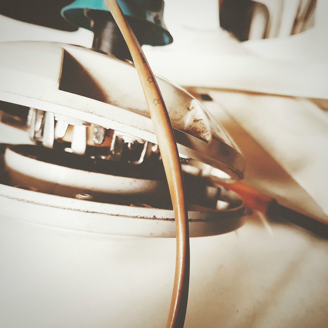 close-up, indoors, music, arts culture and entertainment, musical equipment, musical instrument, still life, no people, selective focus, white color, communication, metal, table, chopsticks, cable, string instrument, kitchen utensil, focus on foreground, detail, technology