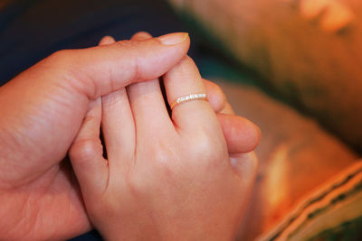 Close-up of couple holding hands