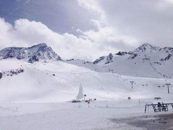 Scenic view of snow covered mountains against sky