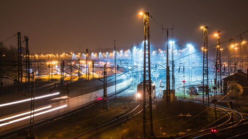 High angle view of light trails on railroad tracks at night