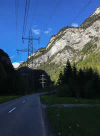 Road by mountain against sky