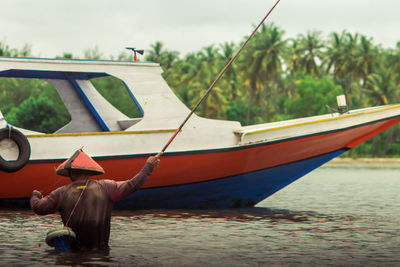 Man in boat against sky