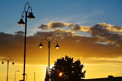 Low angle view of street light against sky during sunset