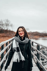 Portrait of young woman standing in snow