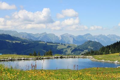 Scenic view of lake and mountains against sky