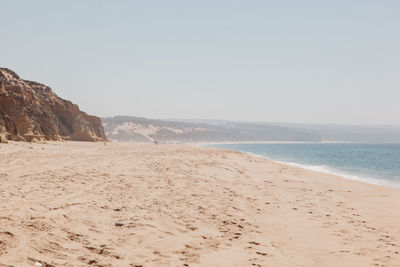 Scenic view of beach against clear sky