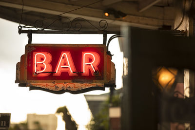 Low angle view of illuminated sign at night