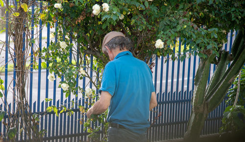 Man standing by plants in yard