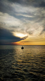 The beauty of the indonesian sea before sunset. with view a boat crashing the waves alone.