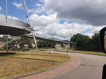 View of city street against cloudy sky