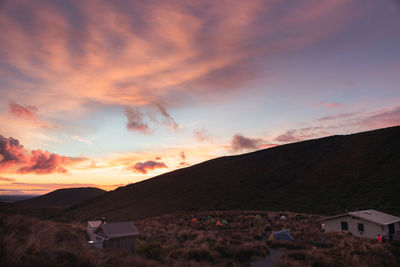 Scenic view of residential buildings against sky during sunset