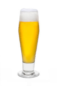 Close-up of beer glass against white background