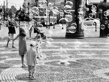 Rear view of women walking on street