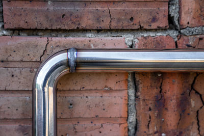 Close-up of faucet on brick wall